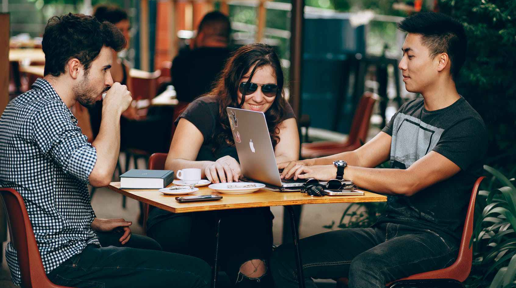 Young people at table with laptop