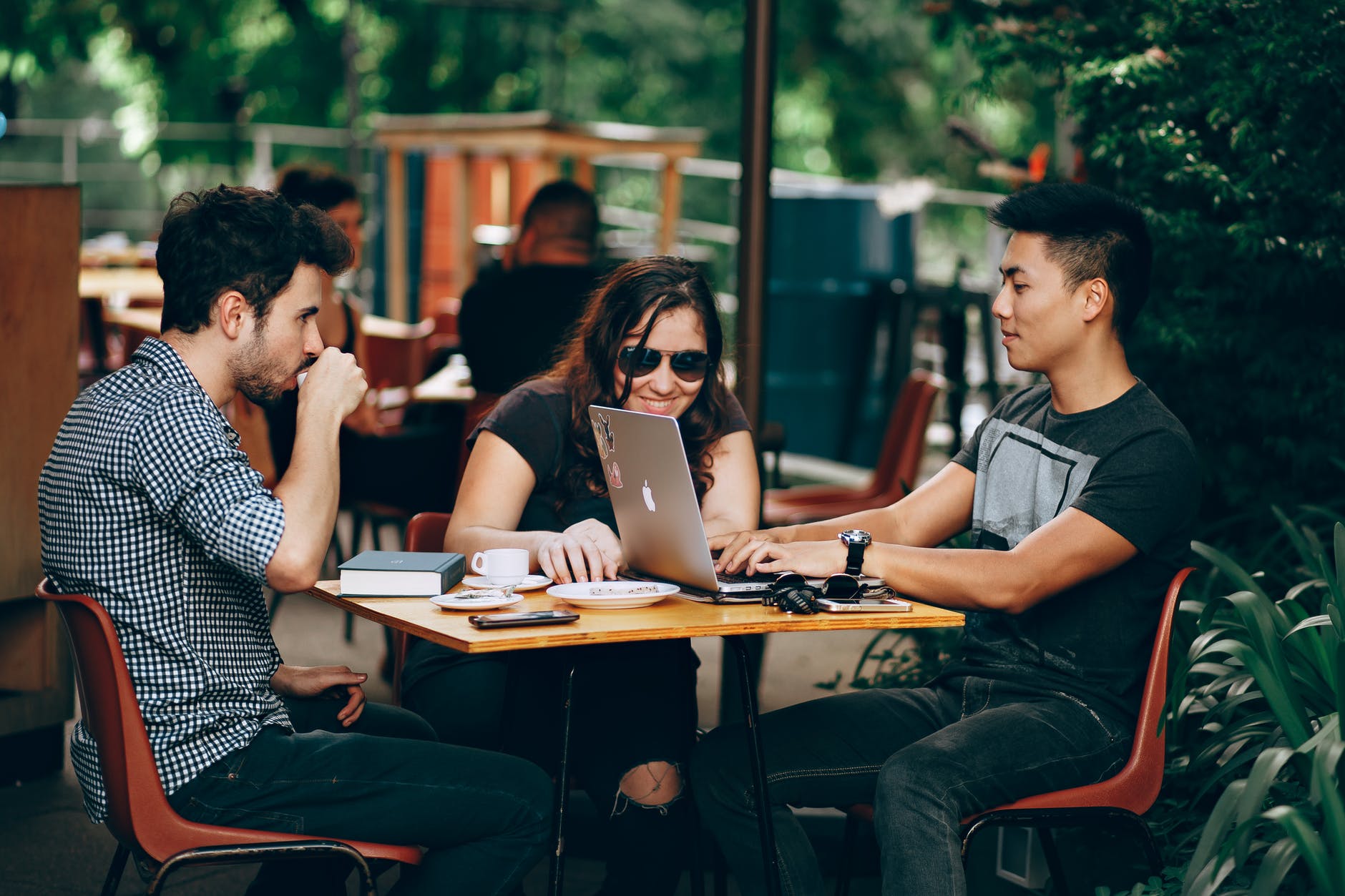 Young people at table with laptop
